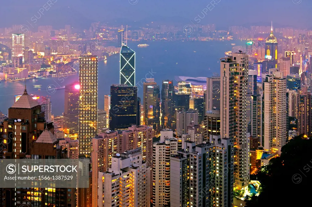 Night view across the skyscrapers in Central District and the Victoria Harbour to Kowloon, Hong Kong.
