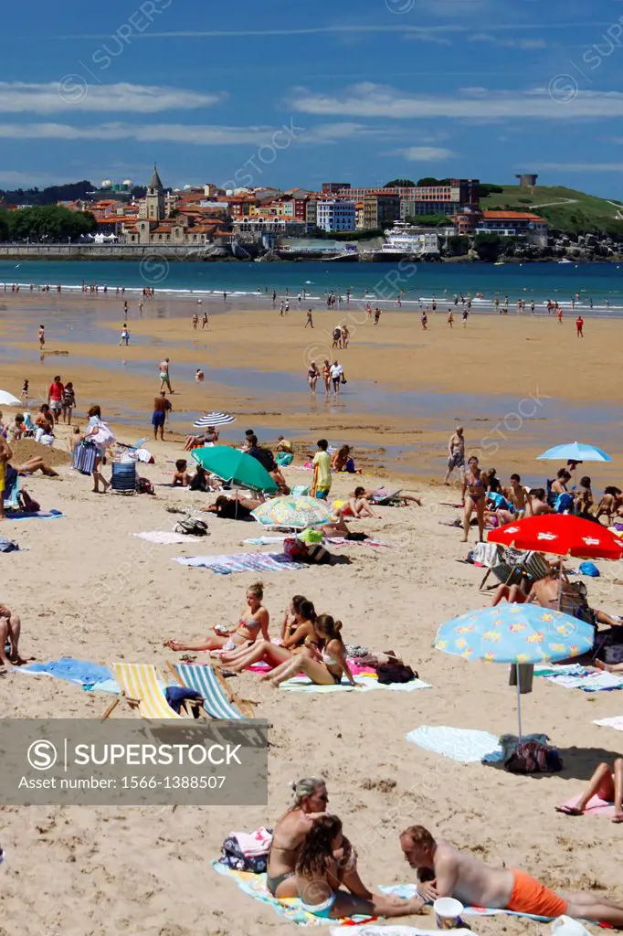Beach of San Lorenzo with umbrellas, city of Gijon, Asturias, Spain.