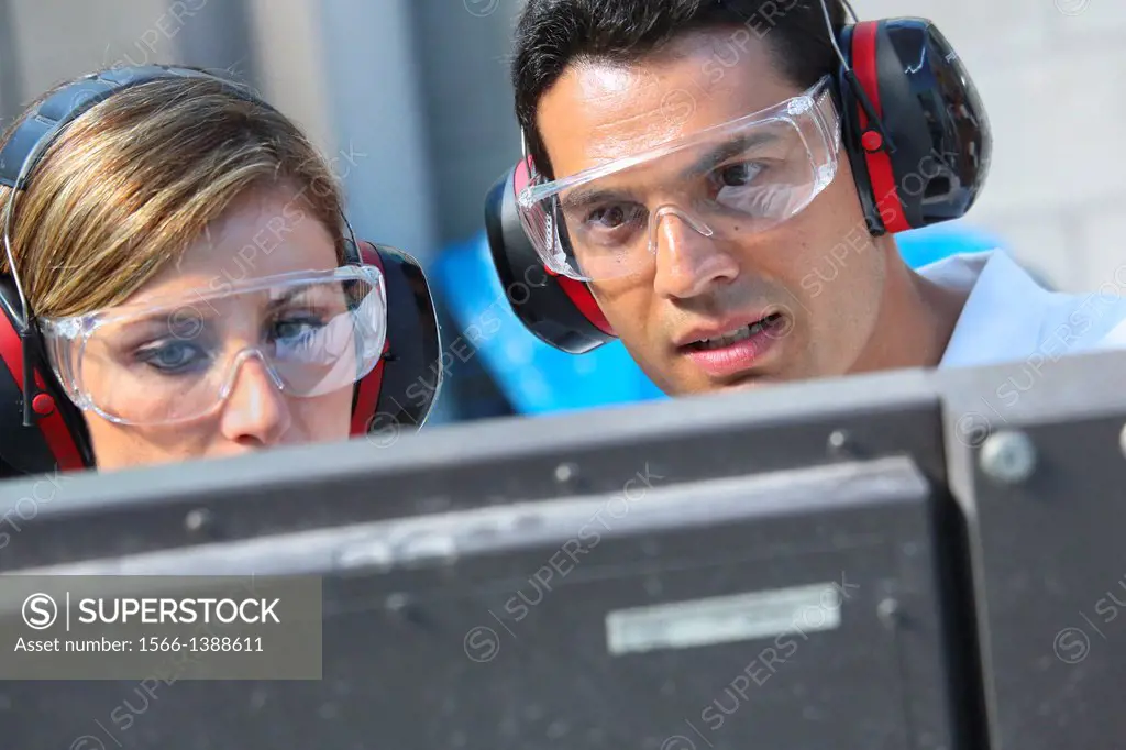 Researchers with glasses and ear protection. Machine for cutting material by water jet and abrasive Industry. Tecnalia Research & innovation. Technolo...