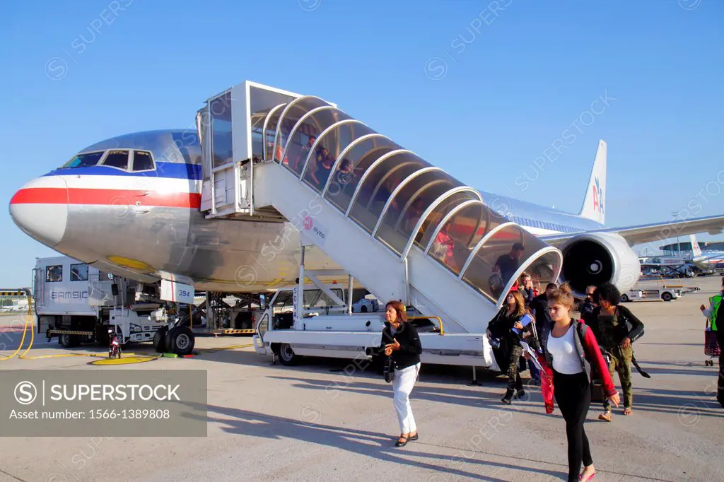 France, Europe, French, Paris, CDG, Charles de Gaulle Airport, American Airline, arriving, passengers, disembarking, tarmac, commercial airliner,.