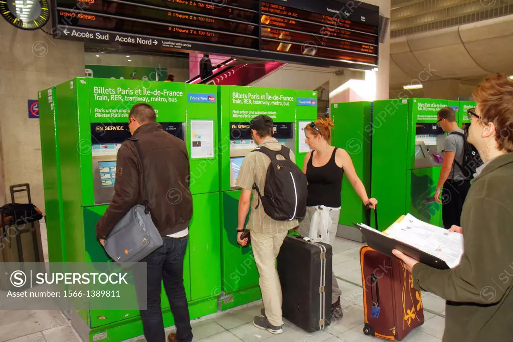 France, Europe, French, Paris, CDG, Charles de Gaulle Airport, ticket vending machine, self service, train, RER, Metro, man, woman, couple, using, gre...
