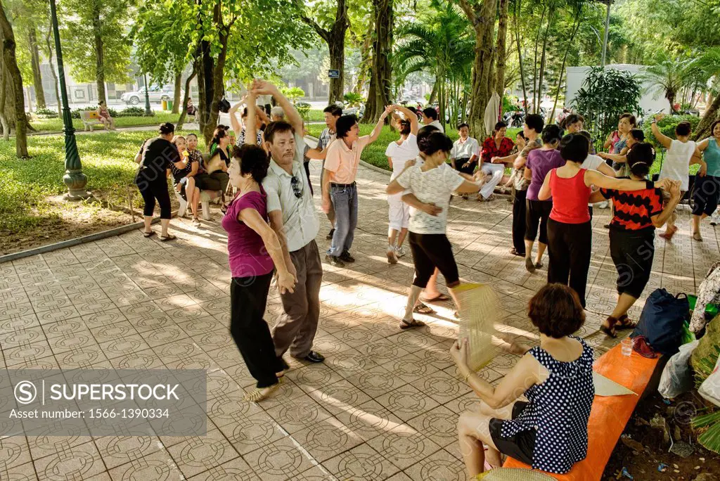 couples ballroom dancing at Hoan Kiem Lake in Hanoi, Vietnam.