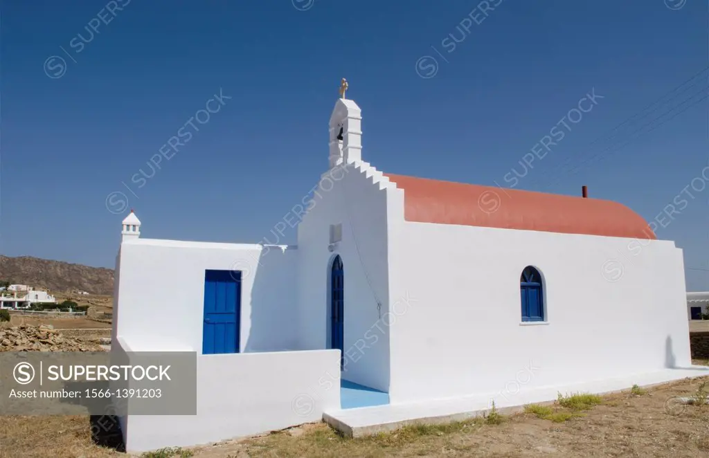 Greece Mykonos Ano Mera small white blue and red Orthodox church in small town.