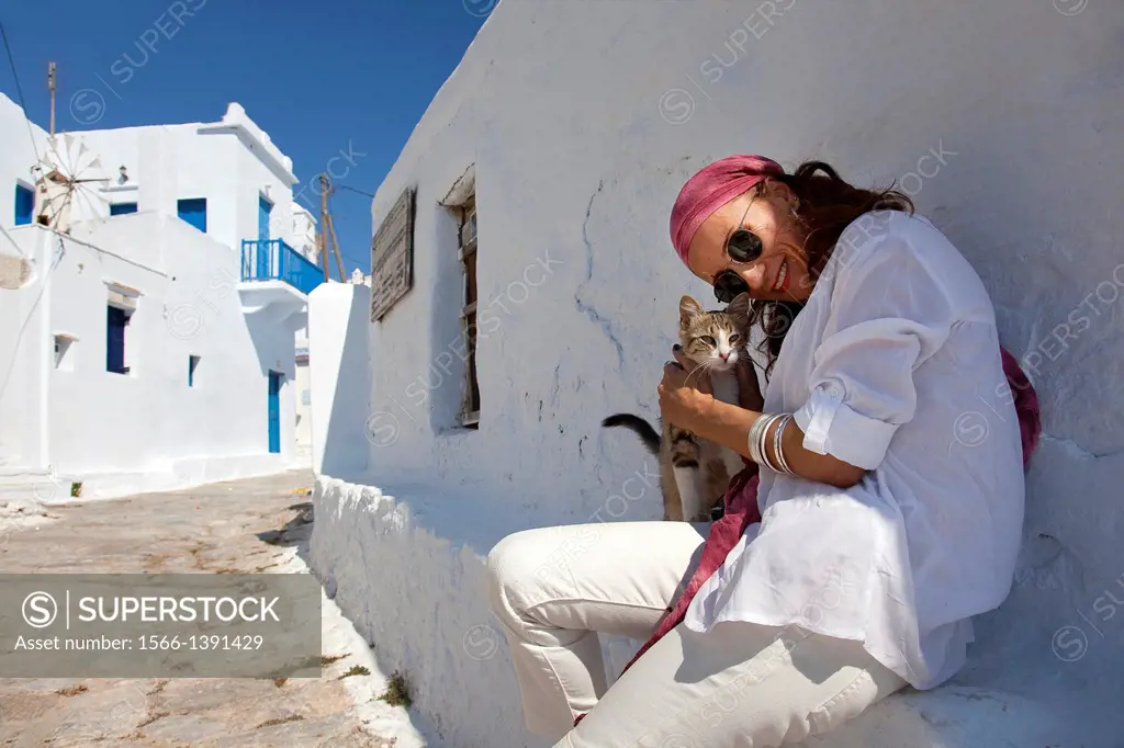 Woman with a local cat, Amorgos, Cyclades Islands, Greek Islands, Greece, Europe.