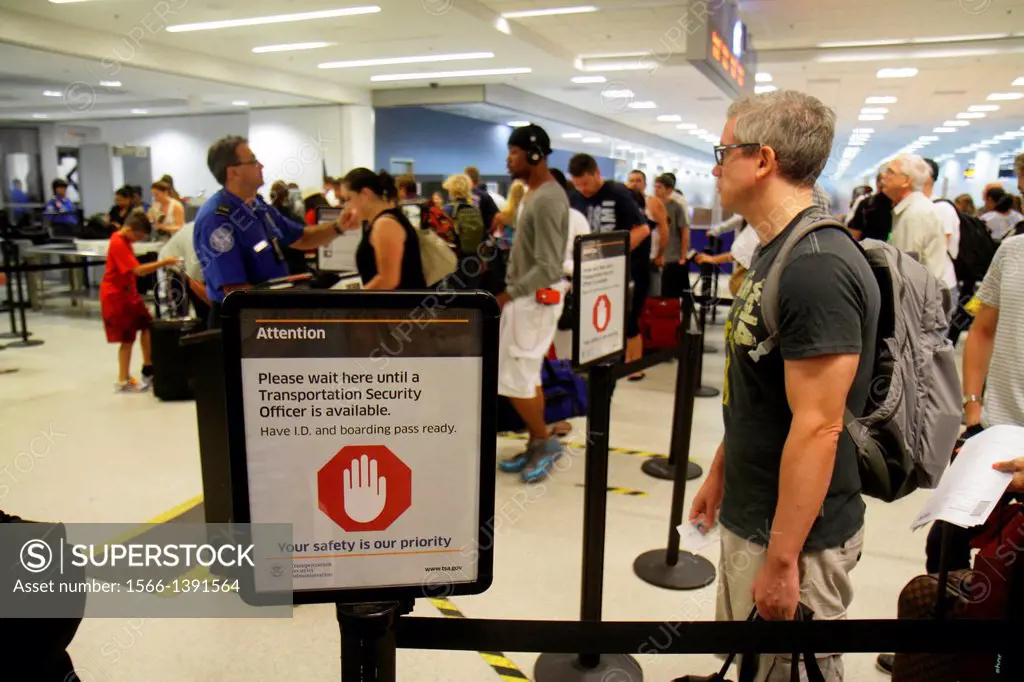 Florida, Miami, Miami International Airport, MIA, terminal, TSA, security, screening, line, queue, man, waiting,.