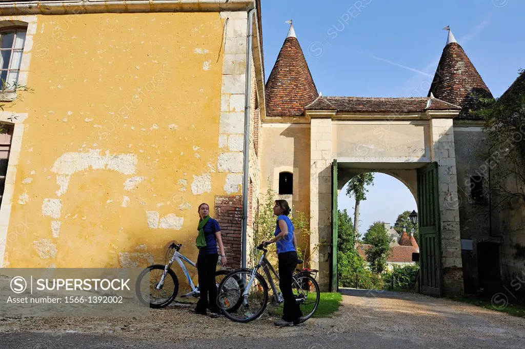 young women going with bicycle into the Domaine de Villeray estate, village of Villeray, Commune of Condeau, Orne department, Lower Normandy region, F...