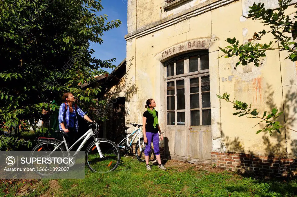 young women in front of the former railway station of Bellou-sur-Huisne, Remalard, Orne department, Lower Normandy region, France, Western Europe.