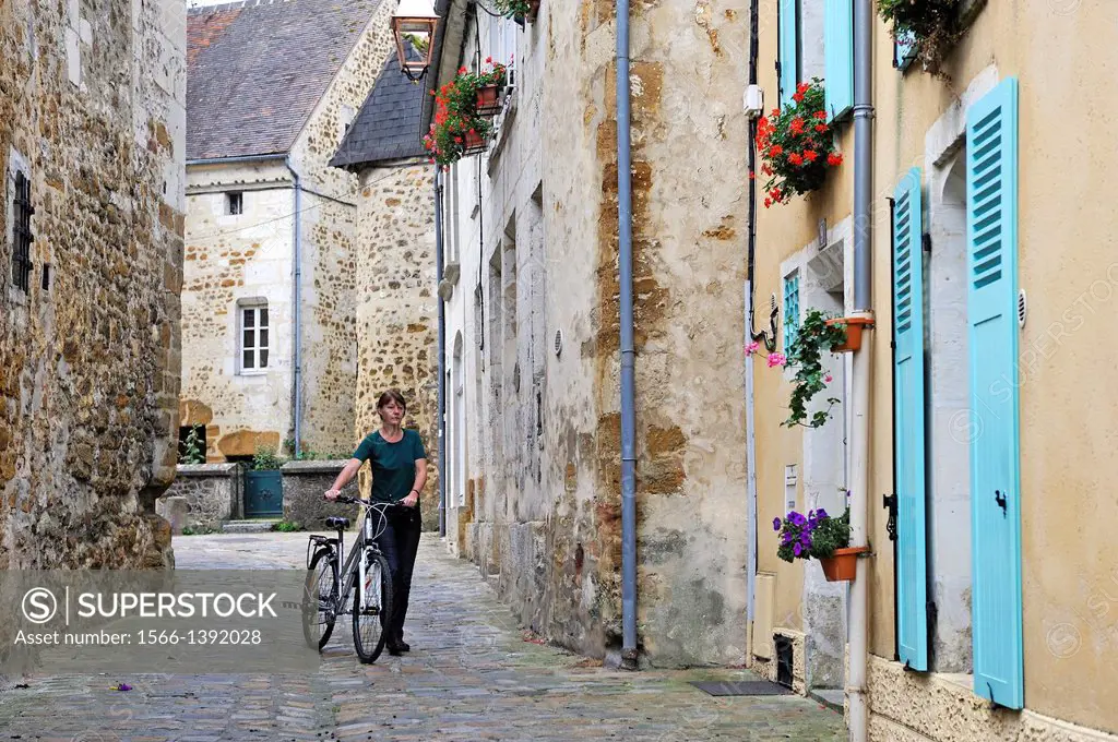 young woman with bicycle, Toussaint street, Mortagne-au-Perche, Regional Natural Park of Perche, Orne department, Lower Normandy region, France, Weste...
