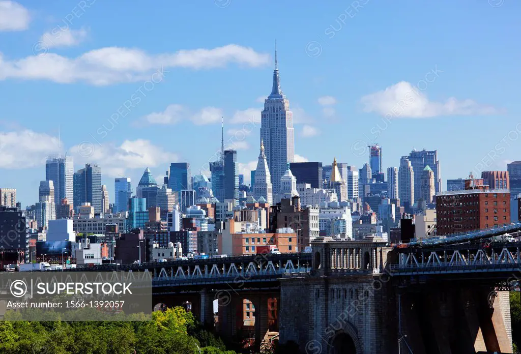 The Empire State building in Midtown and the Manhattan Bridge in New York city, USA.