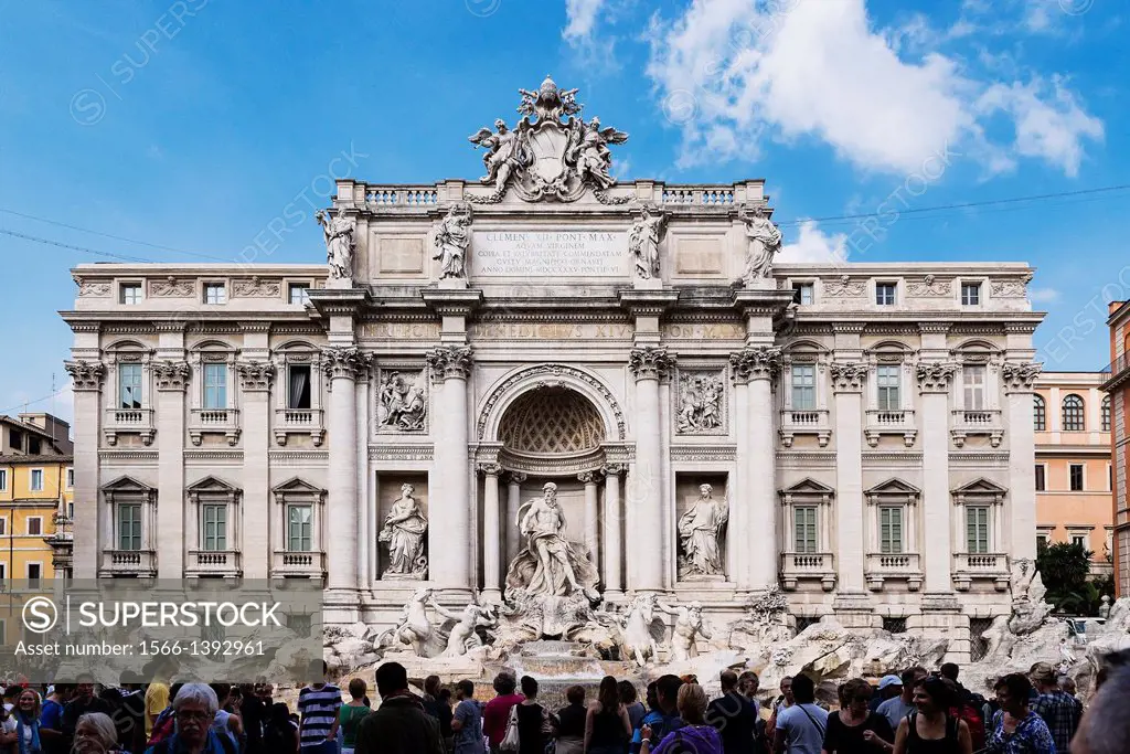 Tourists gather to admire the Trevi Fountain, Rome, Italy.