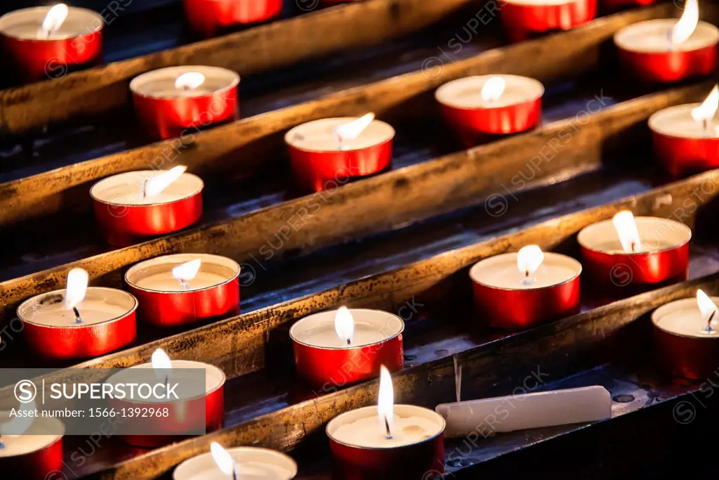 Devotional prayer candles in a Catholic church.