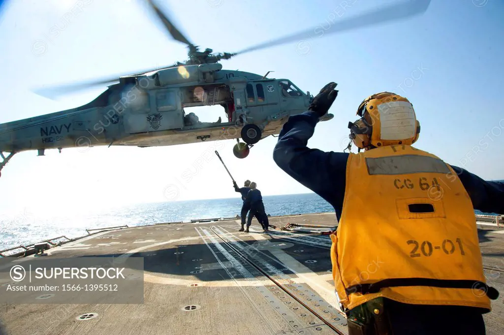 GULF OF OMAN (November 27, 2013) Sailors aboard the guided-missile cruiser USS Gettysburg (CG 64) prepare to attach ´pogo sticks´ to a MH-60S Sea Hawk...