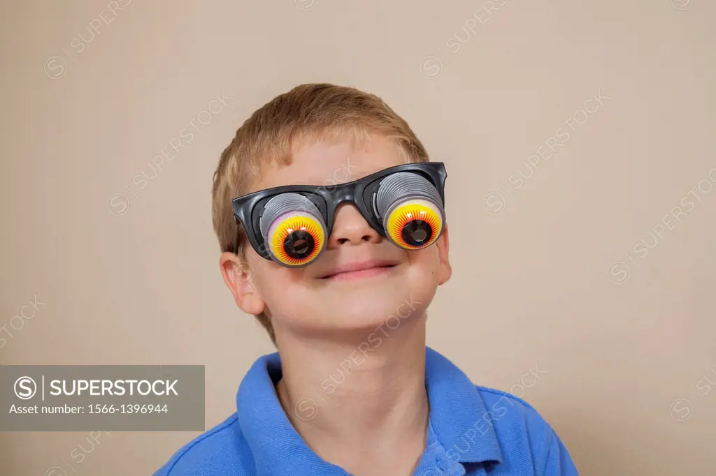 Young boy wearing funny glases.
