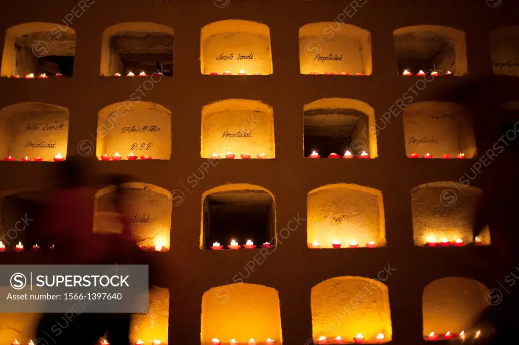 Candles decorate graves of the San Miguel cemetery during the Day of the Dead celebrations in Oaxaca, Mexico. The Day of the Dead celebration is a tra...