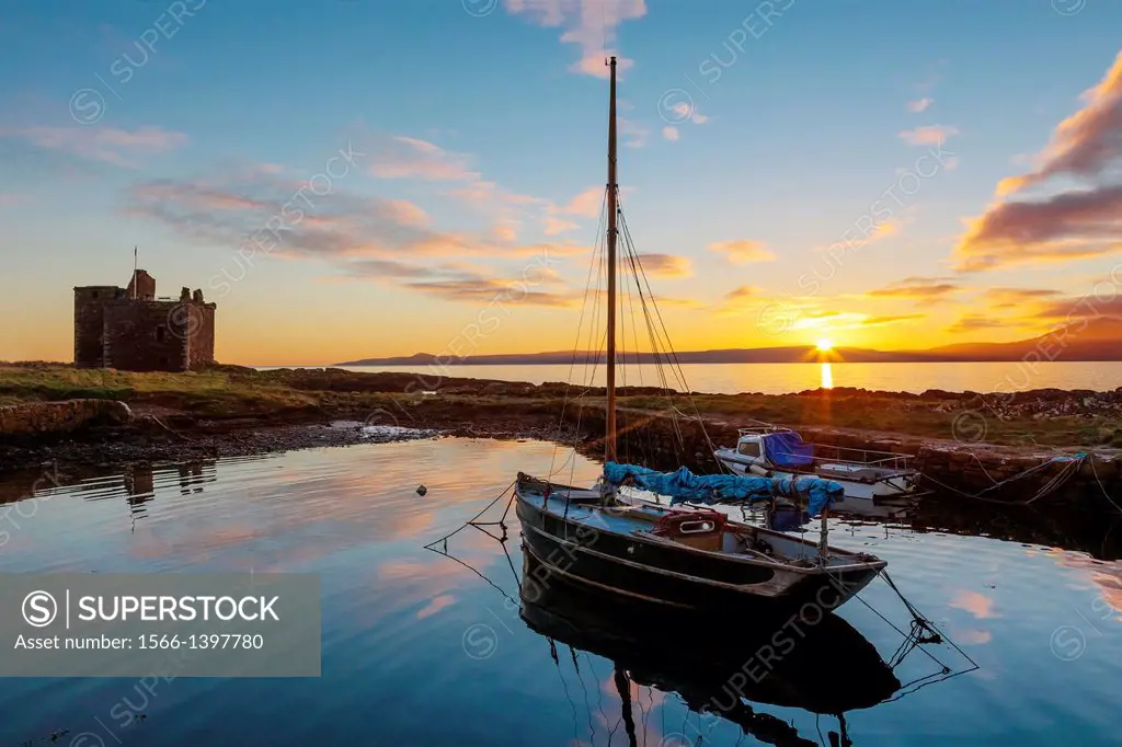 Sunset over the Isle of Arran, Firth of Clyde, Strathclyde, Scotland, UK, Great Britain, viewed from the harbour at Portencross, Ayrshire with Portenc...