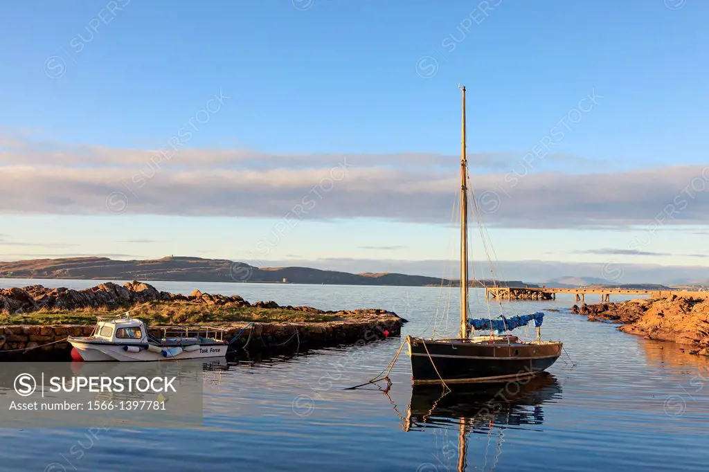 Portencross harbour at sunset, Ayrshire, Scotland, with a view north to the Island of Millport across the Firth of Clyde.