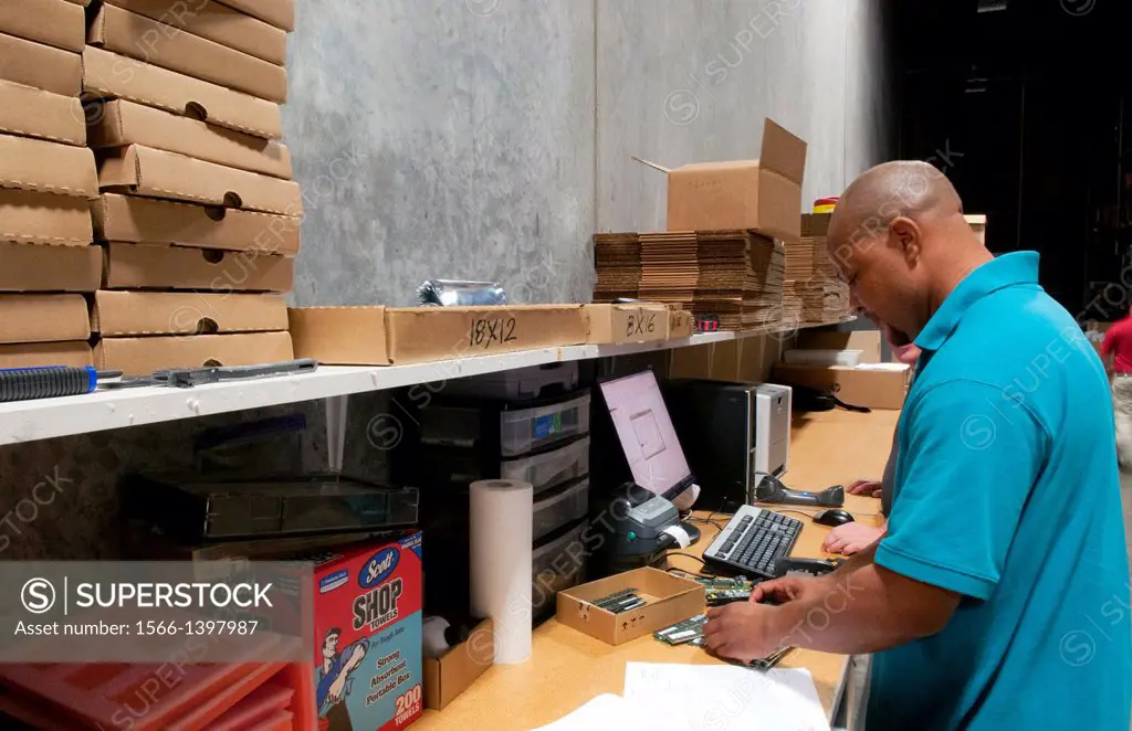 african american man shipping computer technology IT company shipping inventory.