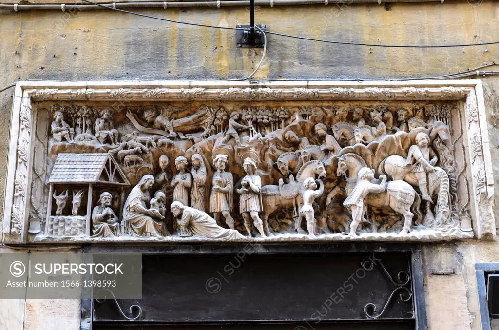 High relief on top of a door by Giovanni Gagini (around 1457) depicting the adoration of the Magi in via degli Orefici street - Genoa, Italy.