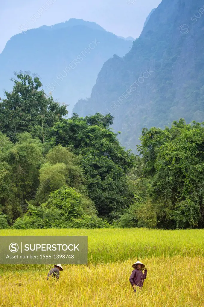 Farmers work the land in the countryside around Vang Vieng, Laos.