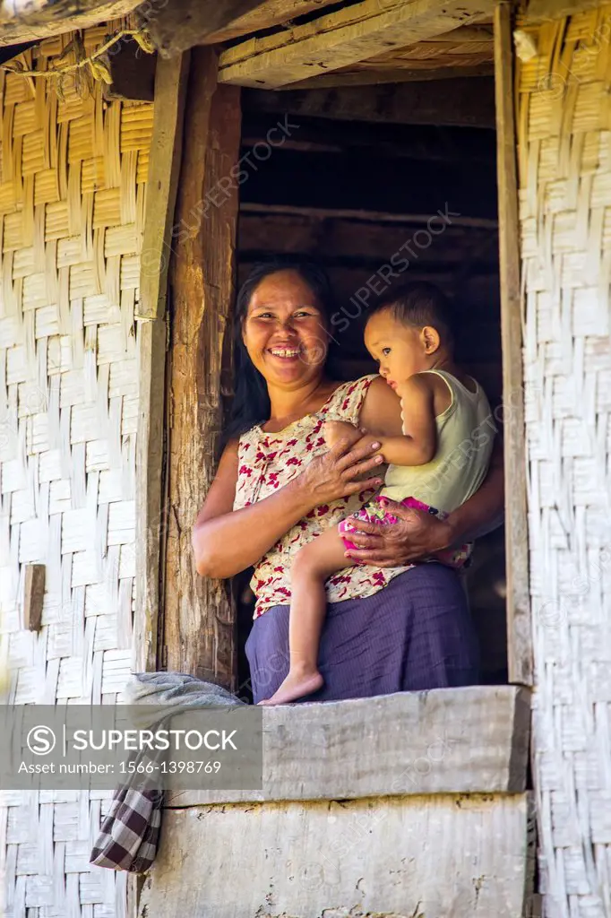 Lao mother & son at thier home near Vang Vieng, Laos.