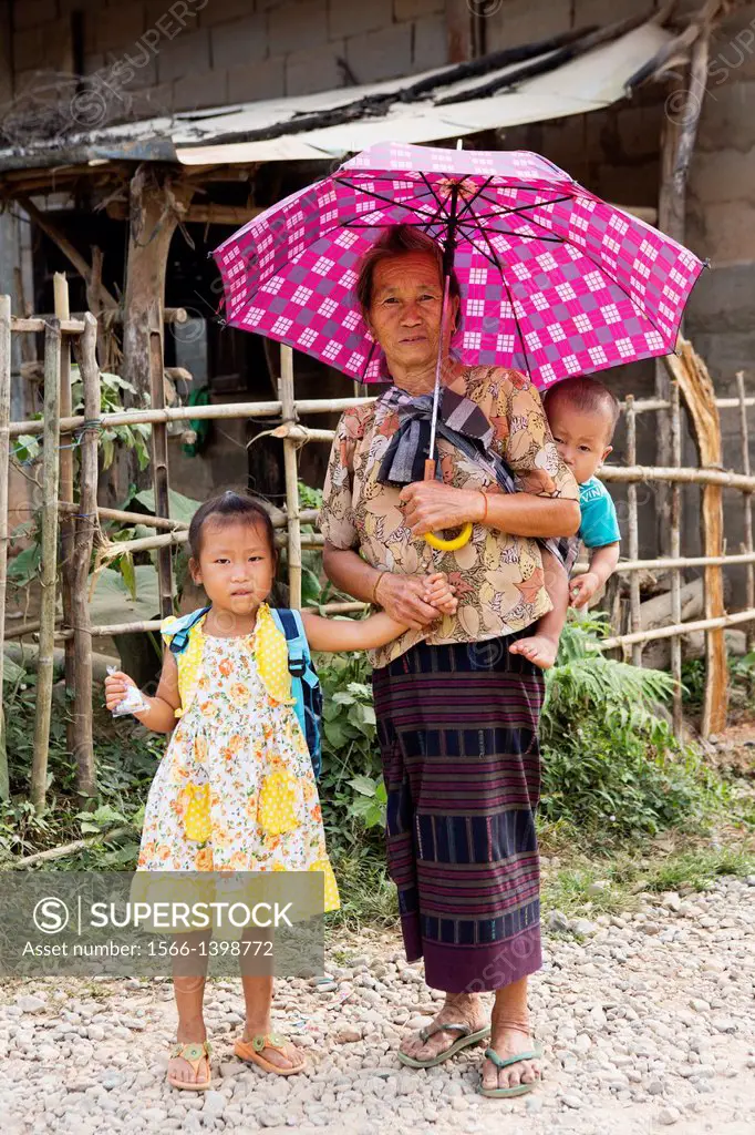 Elderly Lao woman with her grandchildren near Vang Vieng, Laos.