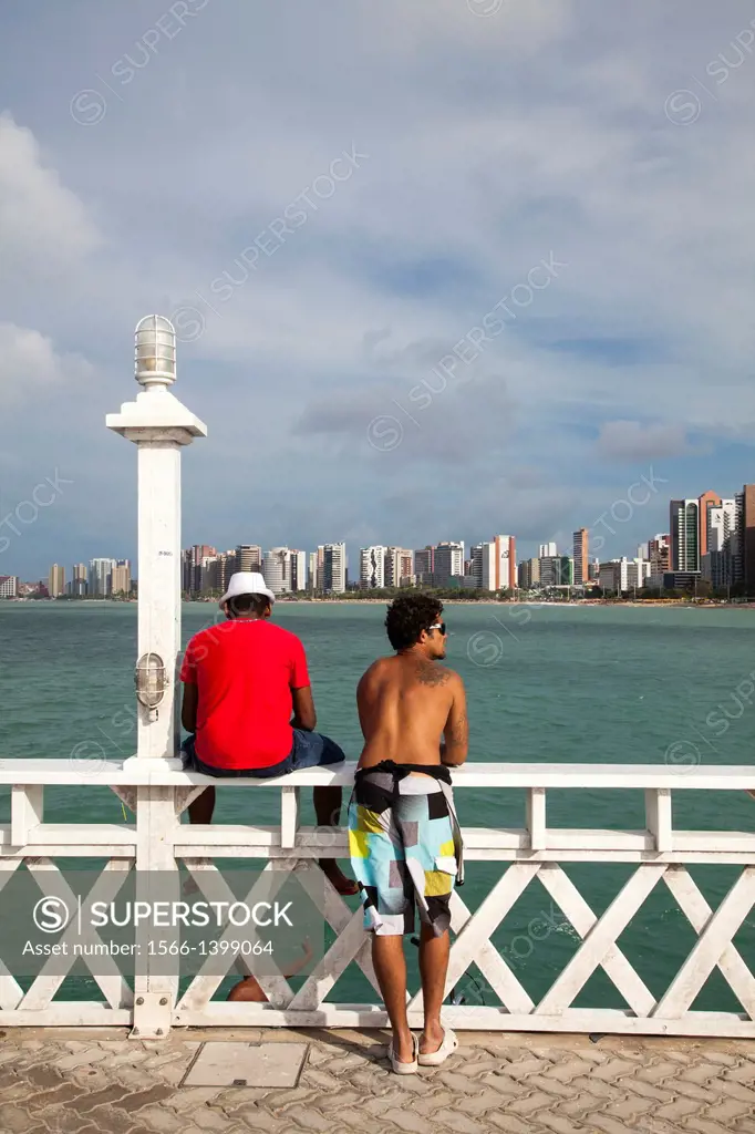 Men looking over the sea, Iracema, Fortaleza, Brazil.