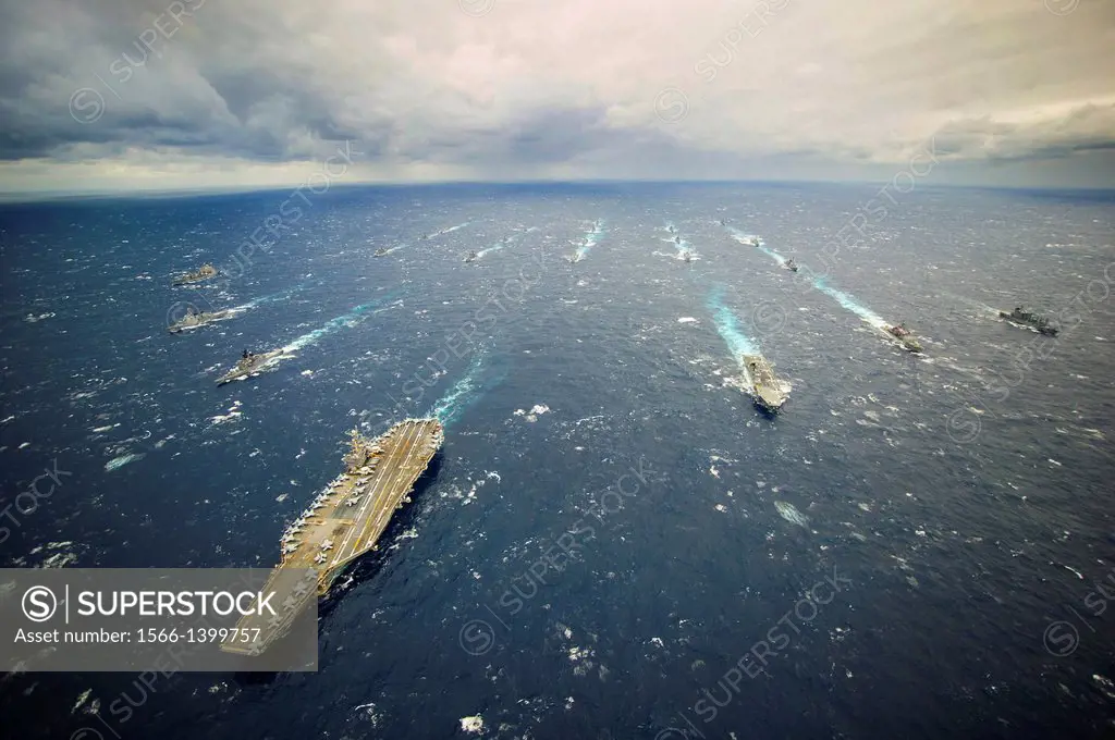 PHILIPPINE SEA (Nov. 28, 2013) The aircraft carrier USS George Washington (CVN 73), center-right, leads the George Washington Carrier Strike Group and...