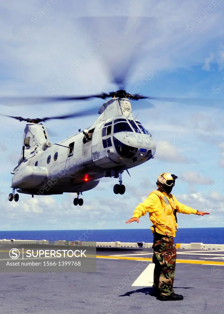 PHILIPPINE SEA (Sept. 19, 2010) Aviation Boatswain's Mate (Handling) Airman Bernard Ugalde directs the lift off of a CH-46E Sea Knight helicopter aboa...