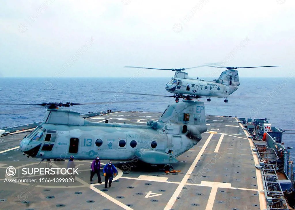 EAST CHINA SEA (Oct. 9, 2011) Two CH-46E Sea Knight helicopters assigned to the Dragons of Marine Medium Helicopter Squadron (HMM) 265 land on the fli...