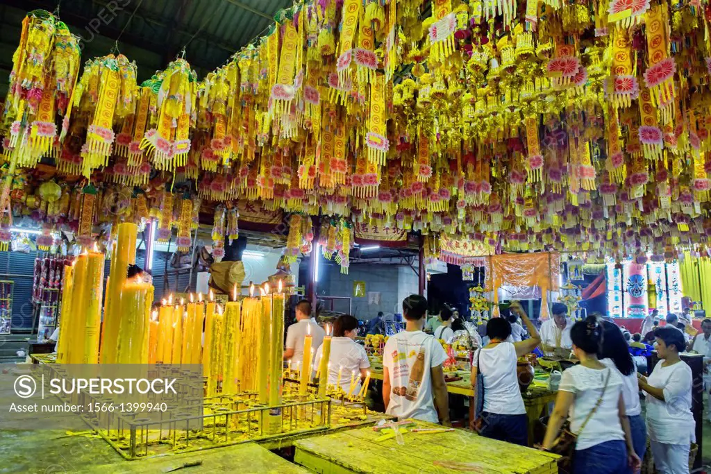 making offerings for good luck at the Vegetarian Festival in Bangkok, Thailand.