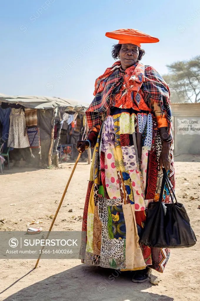 Herero woman dressed with a traditional attire, Opuwo, Namibia, Africa.