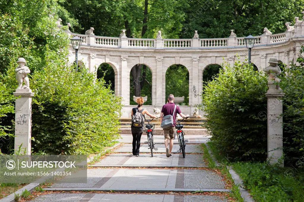 Two Cyclist at the Volkspark Friedrichshain Park by the Marchenbrunnen Fairy Tale Fountain, Berlin, Germany.