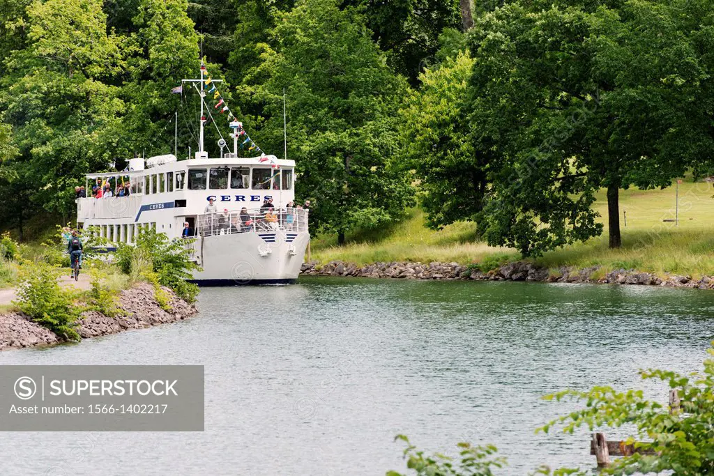 Tranquil summer landscape. Passenger ship on Gota Canal in Sweden.