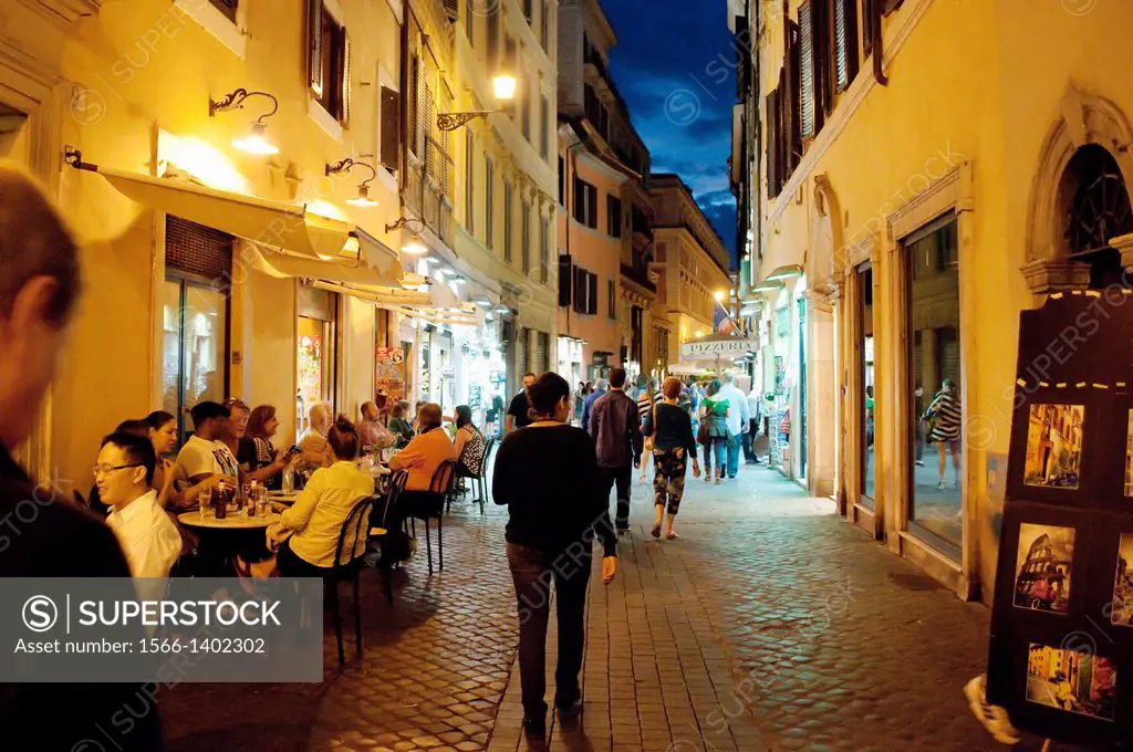 Street restaurants in Trevi district at night, Rome, Italy.