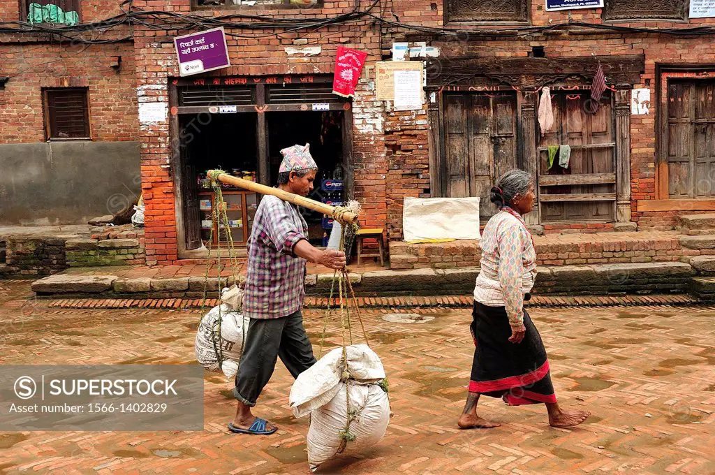Woman and porter man, Bhaktapur, Nepal