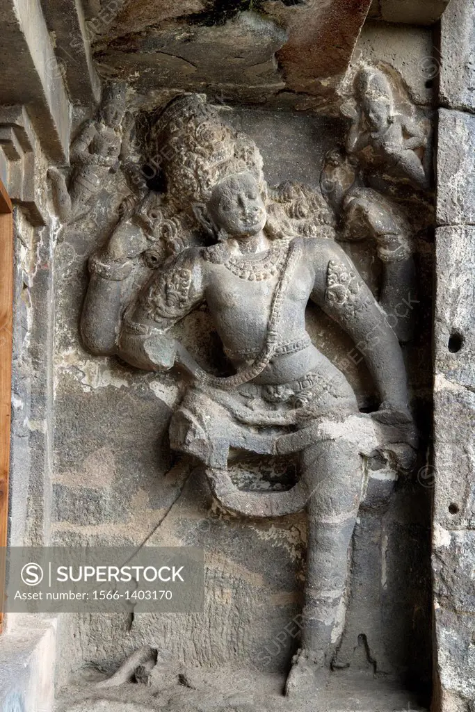 Cave 15, Dashavatara. Four armed Shaiva Dwarapala guardian on the Southern side- facade. Ellora Caves, Aurangabad, Maharashtra India.
