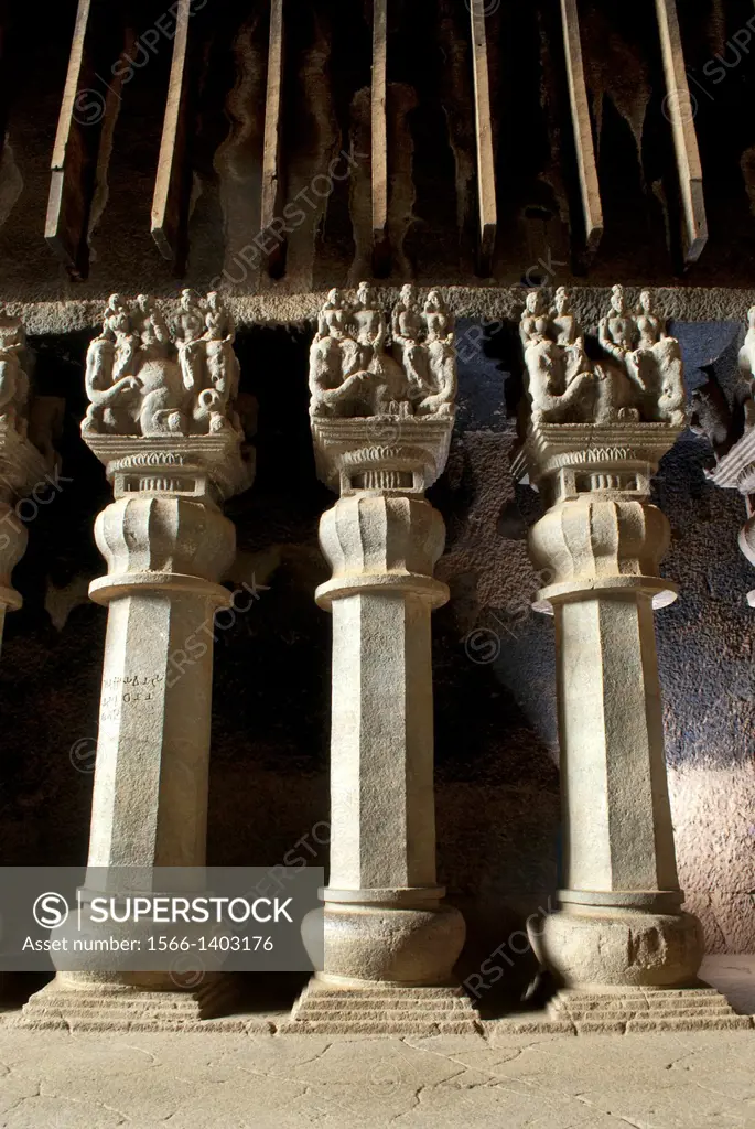 Three pillars- octagonal shaft, inverted bell capital and couples riding elephants. Circa 2nd. Century CE Karla Caves, dist Pune, Maharashtra, India