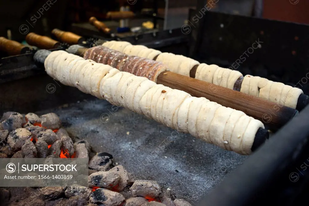 Trdelník Stalls. The Trdelnik is a mass of flour, sugar, egg, yeast, cinnamon and milk that is stretched and wound onto a wooden stick (Trdlo) or meta...