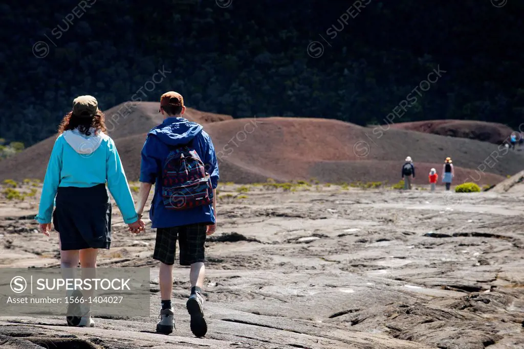 A couple making a trek over the lava of volcano Piton de la Fournaise. Reunion Island is formed by two volcanoes stratum mainly basaltic composition, ...