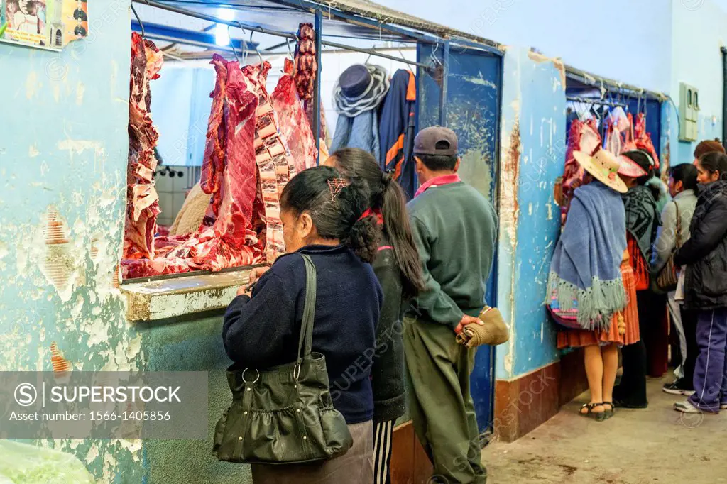 Local people shopping for fresh meat in the market, Uyuni, Bolivia, South America.