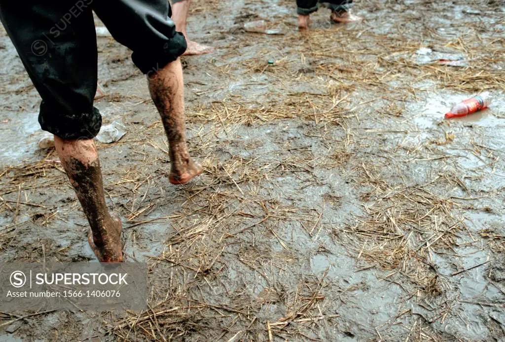 Young people dancing barefoot in the mud
