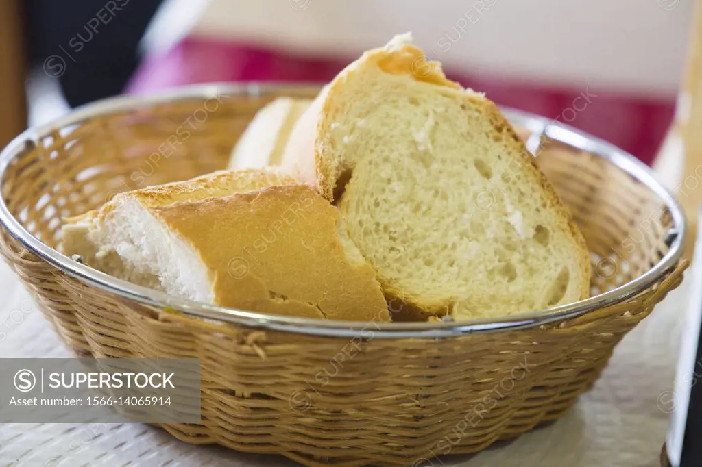 Bread slices in basket on table restaurant Spain