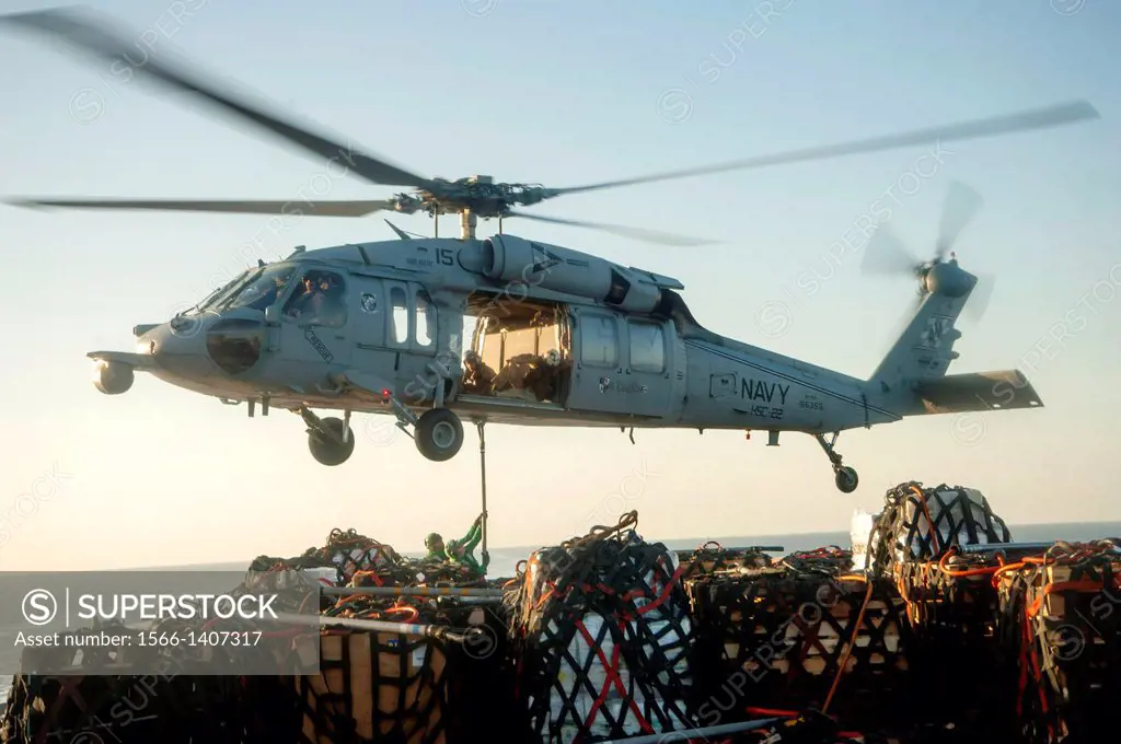 GULF OF OMAN (Dec. 4, 2013) An MH-60S Sea Hawk helicopter assigned to the Sea Knights of Helicopter Sea Combat Squadron (HSC) 22 receives cargo on the...