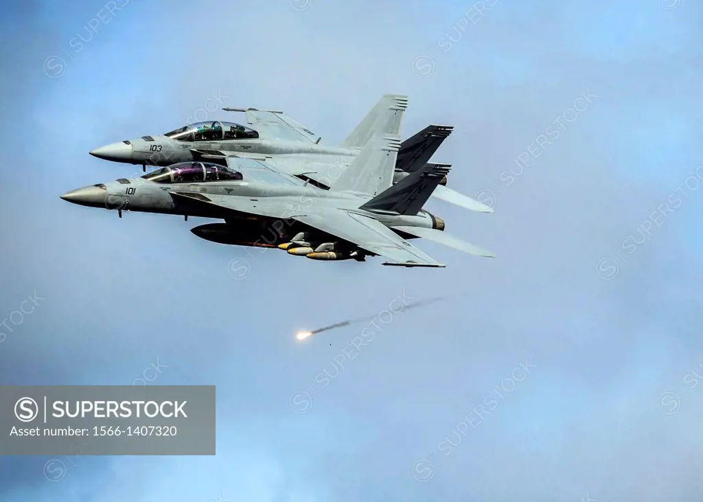 PACIFIC OCEAN (Dec. 7, 2013) Two F/A-18F Super Hornets, assigned to the ´Black Knights´ of Strike Fighter Squadron (VFA) 154, shoot flares as they pa...