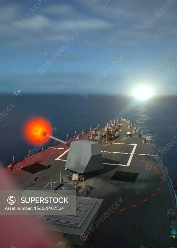 ATLANTIC OCEAN Dec. 08, 2013 The Arleigh Burke-class guided-missile destroyer USS Truxtun DDG 103 fires its MK 45 5-inch gun at a simulated target. Tr...