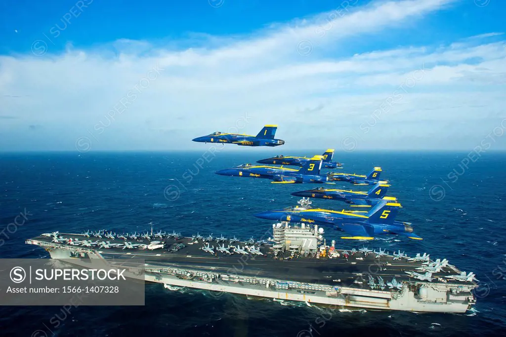 ATLANTIC OCEAN (Dec. 10, 2014) The U.S. Navy flight demonstration squadron, the Blue Angels, fly in the Delta Formation over the aircraft carrier USS ...