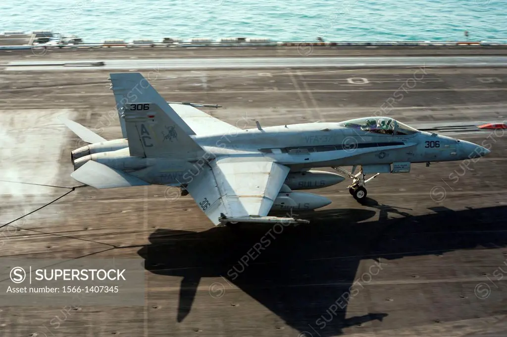 ARABIAN GULF (Dec. 19, 2013) An F/A-18C Hornet assigned to the Ragin Bulls of Strike Fighter Squadron (VFA) 37 lands on the flight deck of the aircra...