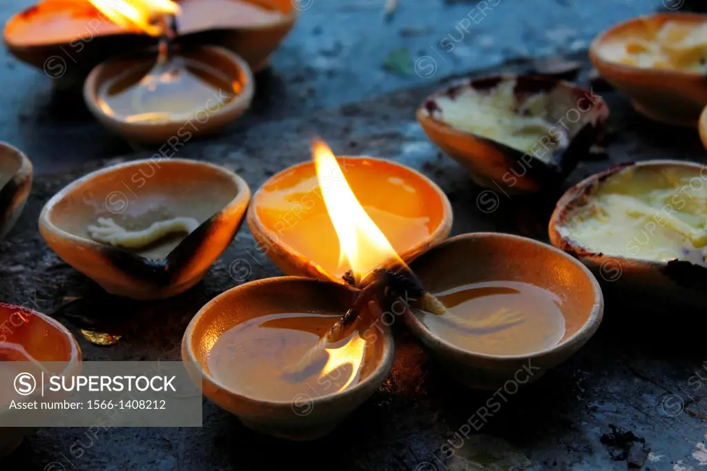 Candles with oil inside the sacred temple near Batu Caves who are a set of caves, some of which have been converted into temples, in a limestone hill ...