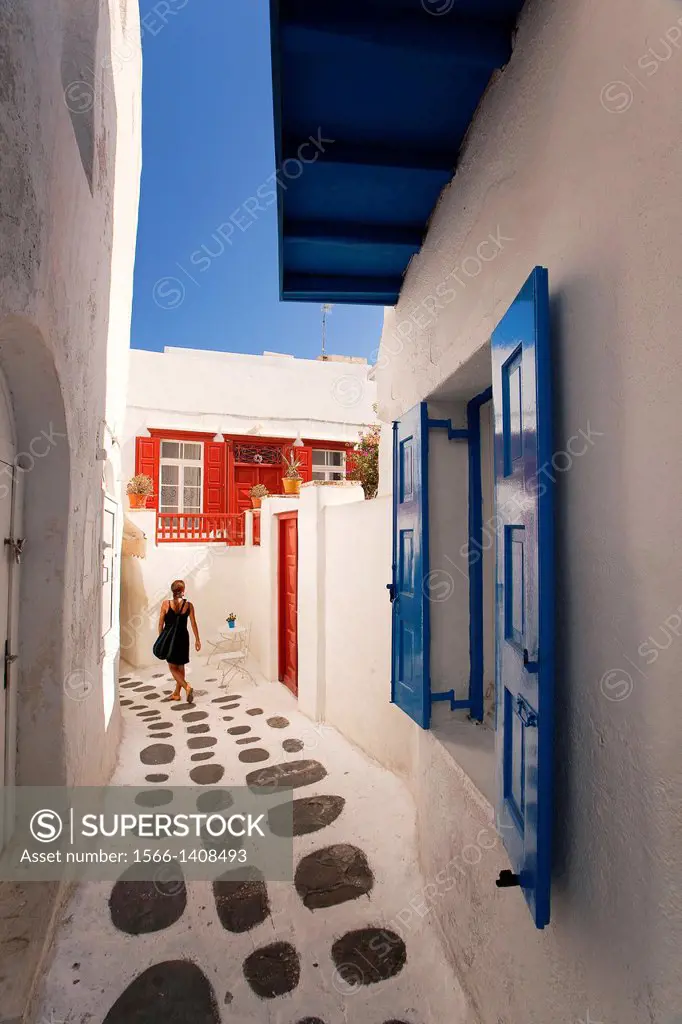 Woman in the alleys of town center, Mykonos, Cyclades Islands, Greek Islands, Greece, Europe.