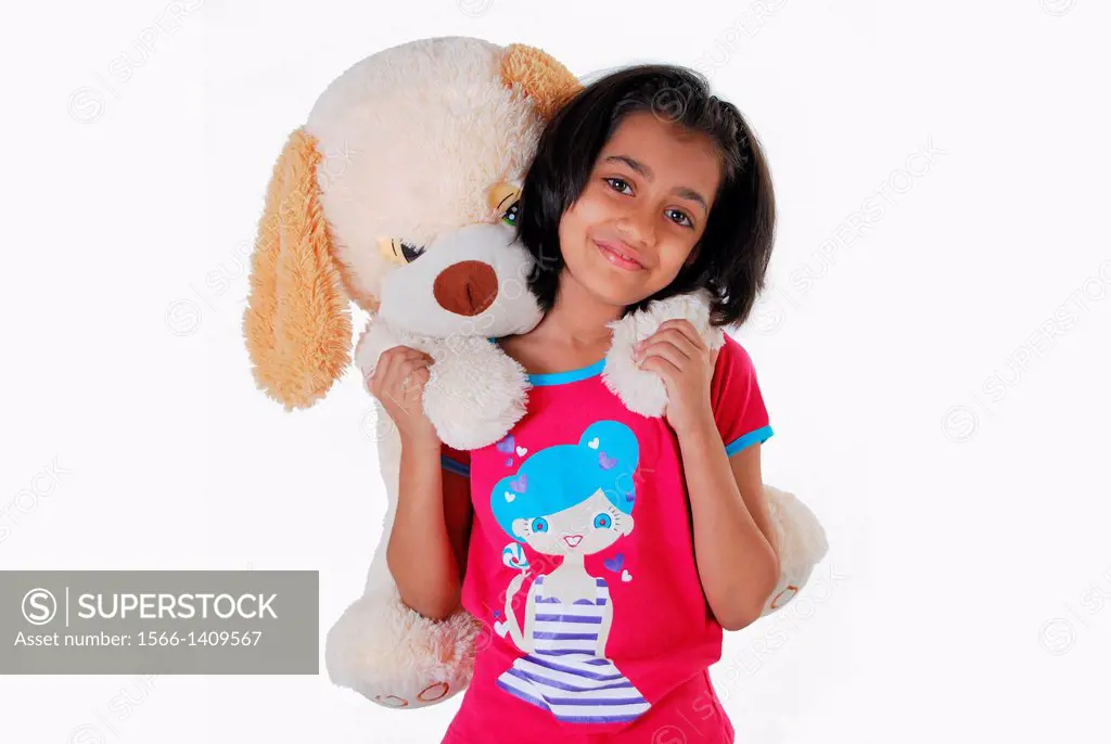 Girl with a teddy bear on her back, Pune, India.